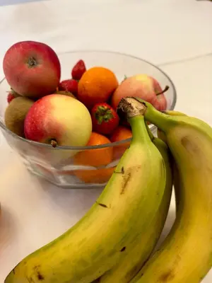 a bowl of fruit with two bananas and a bowl of apples at Cross Hands Hotel in Llanybydder