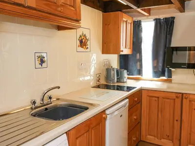 a kitchen with a sink and a counter top at Ty Bach Twt in Llandysul