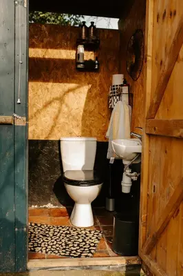 a bathroom with a toilet and a sink at Kestrel lodge in Wrexham