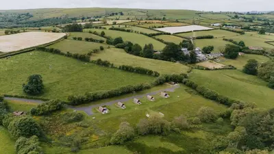 an aerial view of a field with a farm at Brecon by Wigwam Holidays in Brecon
