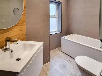 a bathroom with a sink and a tub and a toilet at Uk47852 - No 1B in Aberystwyth