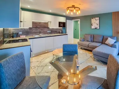 a kitchen and a living room with a glass table at Uk47853 - No 2B in Aberystwyth
