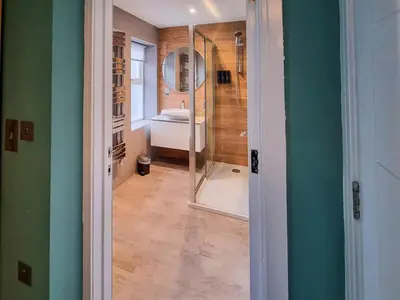 a bathroom with a shower and a toilet and a mirror at Uk47853 - No 2B in Aberystwyth