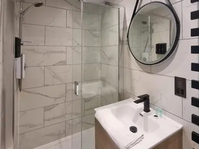 a bathroom with a sink and a shower with a mirror at Uk47853 - No 2B in Aberystwyth