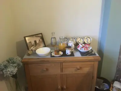 a small wooden cabinet with food on top of it at Garth Engan B&B with private lounge in Llanbedr