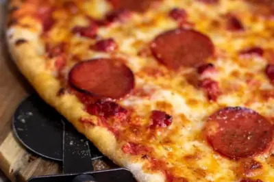 a pepperoni pizza sitting on top of a spatula at The Boughton Peterchurch - Pub Grub & Bed in Peterchurch