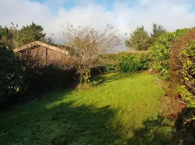 a grassy yard with a house in the background at Gwel-y-Cwm - Valley View in Trawsfynydd