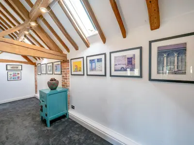 a room with paintings on the wall and a blue cabinet at Countryside home 5 minutes from Ludlow - Pass the Keys in Ludlow