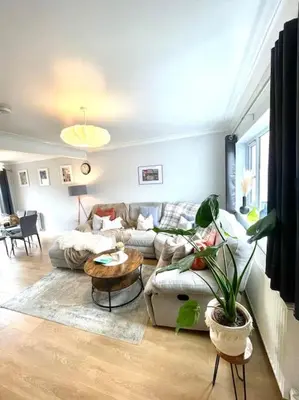 a living room with a couch and a table at Pet friendly, spacious house, sleeps 6 in Llanbadarn-fawr