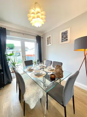 a dining room with a glass table and chairs at Pet friendly, spacious house, sleeps 6 in Llanbadarn-fawr