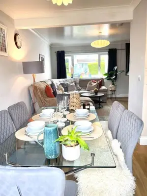 a living room with a table and a couch at Pet friendly, spacious house, sleeps 6 in Llanbadarn-fawr