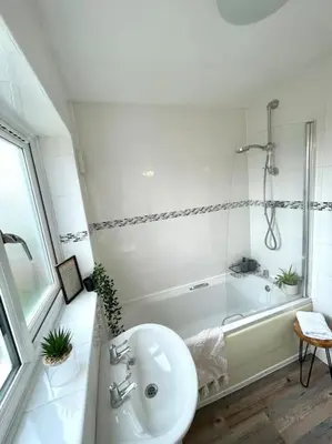a white bathroom with a sink and a tub at Pet friendly, spacious house, sleeps 6 in Llanbadarn-fawr