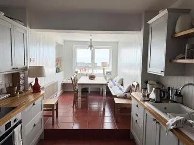 a kitchen with a table and a dining room at Morwylfa Borth and Ynyslas in Borth