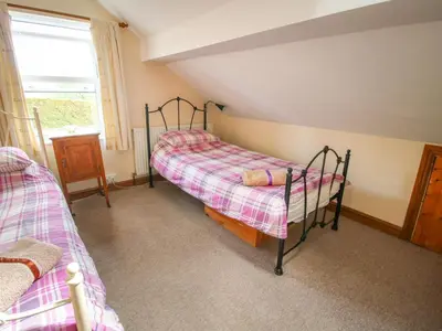 a bedroom with two bunk beds and a window at Old Bricklayer's Arms in Bishops Castle