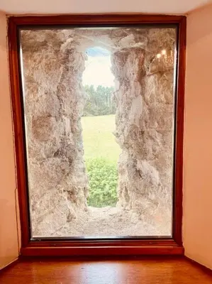 a window in a room with a stone wall at Tawny Owl Barn in Leintwardine