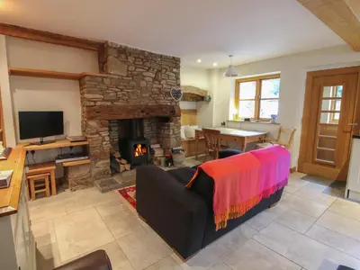 a living room with a couch and a fireplace at New Inn Cottage in Church Stretton
