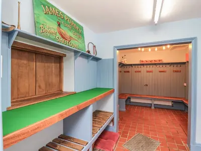 a locker room with a green counter and a bench at Llwynderw Hall in Llanwrtyd Wells