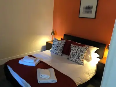 a bedroom with a bed with two towels on it at Ty Morgan's Apartments in Rhayader