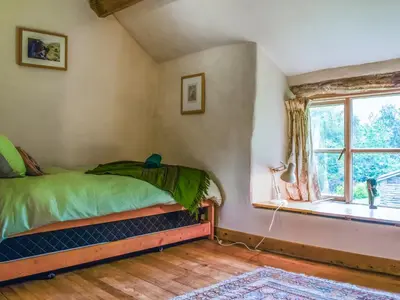 a bedroom with a bed and a window at Cwmberwyn in Llansaintfraed in Elvel