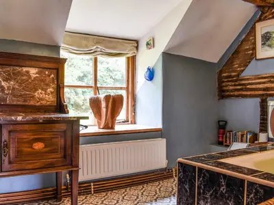 a bedroom with a bed and a window at Cwmberwyn in Llansaintfraed in Elvel