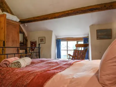 a bedroom with a large bed and a window at Cwmberwyn in Llansaintfraed in Elvel
