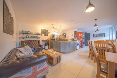 a living room with a couch and a table at River Wye Hostel in Hereford