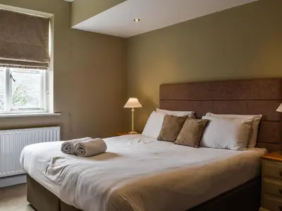 a bedroom with a large bed with towels on it at Uk47787 - Flat 5E in Aberystwyth