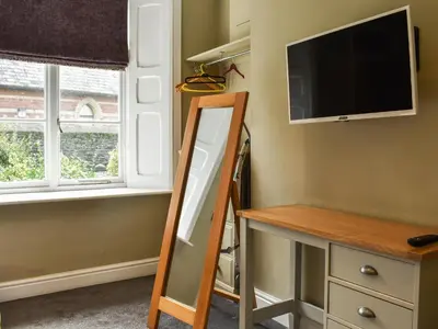 a mirror in a room with a tv and a desk at Flat 3E - Uk47858 in Aberystwyth
