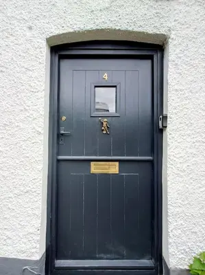 a blue door with a sign on it at Cosy Welsh Town Cottage in Brecon