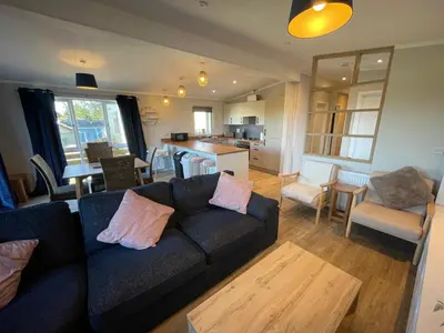 a living room with a couch and a kitchen at Mountain View Brown lodge in Aberystwyth