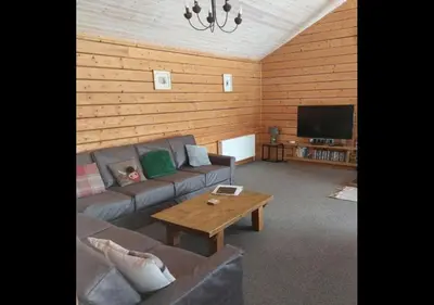 a living room with a couch and a coffee table at Owl Cabin in Llanbrynmair