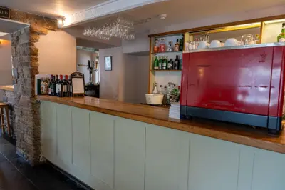 a bar with a red counter in a restaurant at Glan Yr Afon in Pennal