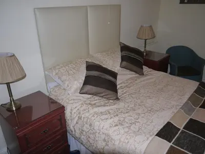 a bedroom with a bed with two pillows on it at Ivy House B&B in Dolgellau