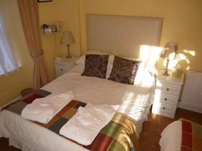 a bedroom with a bed with towels on it at Ivy House B&B in Dolgellau