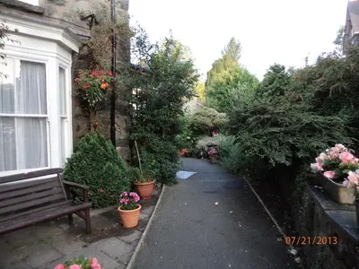a garden with a bench and some plants and flowers at Ivy House B&B in Dolgellau