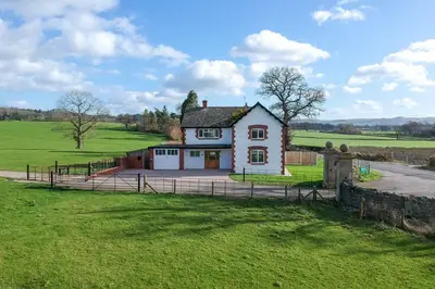 a house in the middle of a field at Marrington Lodge in Chirbury
