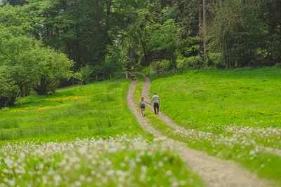 a man and a child walking down a dirt road at Marrington Lodge in Chirbury