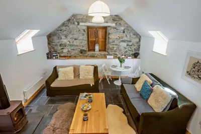 a living room with a couch and a table at 1 Bed in Brithdir oc-w30045 in Rhydymain