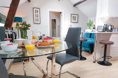 a kitchen with a glass table with food on it at The Annexe in Chirbury