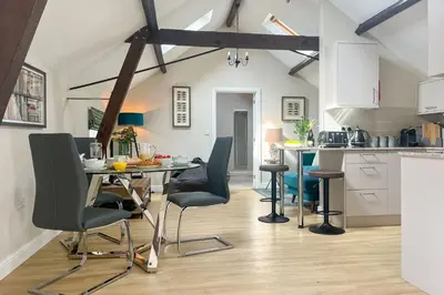a kitchen and dining room with a table and chairs at The Annexe in Chirbury