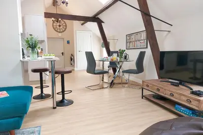 a living room with a table and chairs and a tv at The Annexe in Chirbury