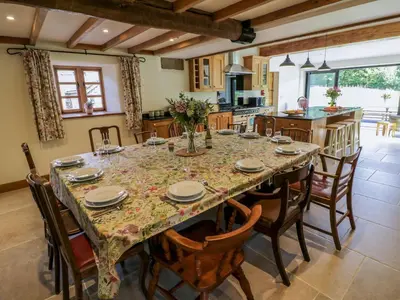a large dining room with a table and chairs at Grove Farm in Church Stretton