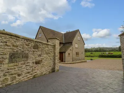 a stone wall in front of a house at Grove Farm in Church Stretton