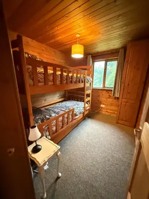 a bedroom with two bunk beds in a log cabin at Glamping Life Retreat in Nantmel