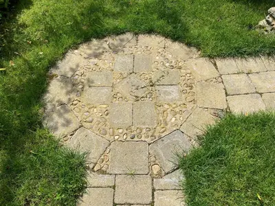 a stone walkway in the grass in a field at Studio in medieval Welsh farmhouse in Aber Cowarch