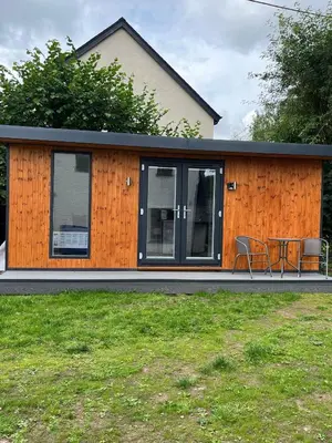 a tiny house with a table and chairs in it at Ty Sycamore in Talybont