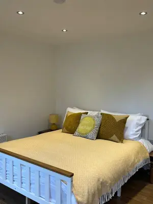 a bed with pillows on it in a room at Ty Sycamore in Talybont