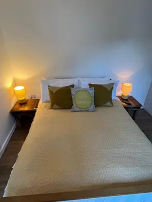 a bedroom with a large bed with two lamps at Ty Sycamore in Talybont