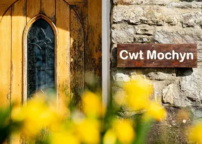 a sign on the side of a building at Cwt Mochyn Aberaeron in Cross Inn