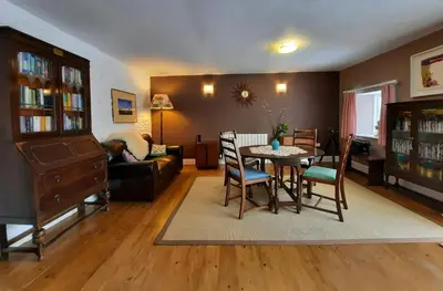 a living room with a table and chairs at Hen Ffermdy Aberaeron in Cross Inn